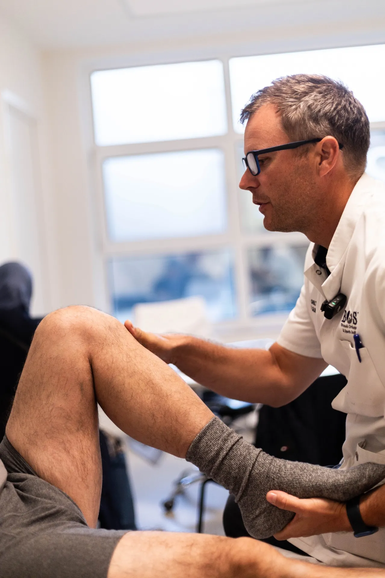 Le Dr Arnaud Deltour examine le genou d’un patient lors d’une consultation à Bruxelles